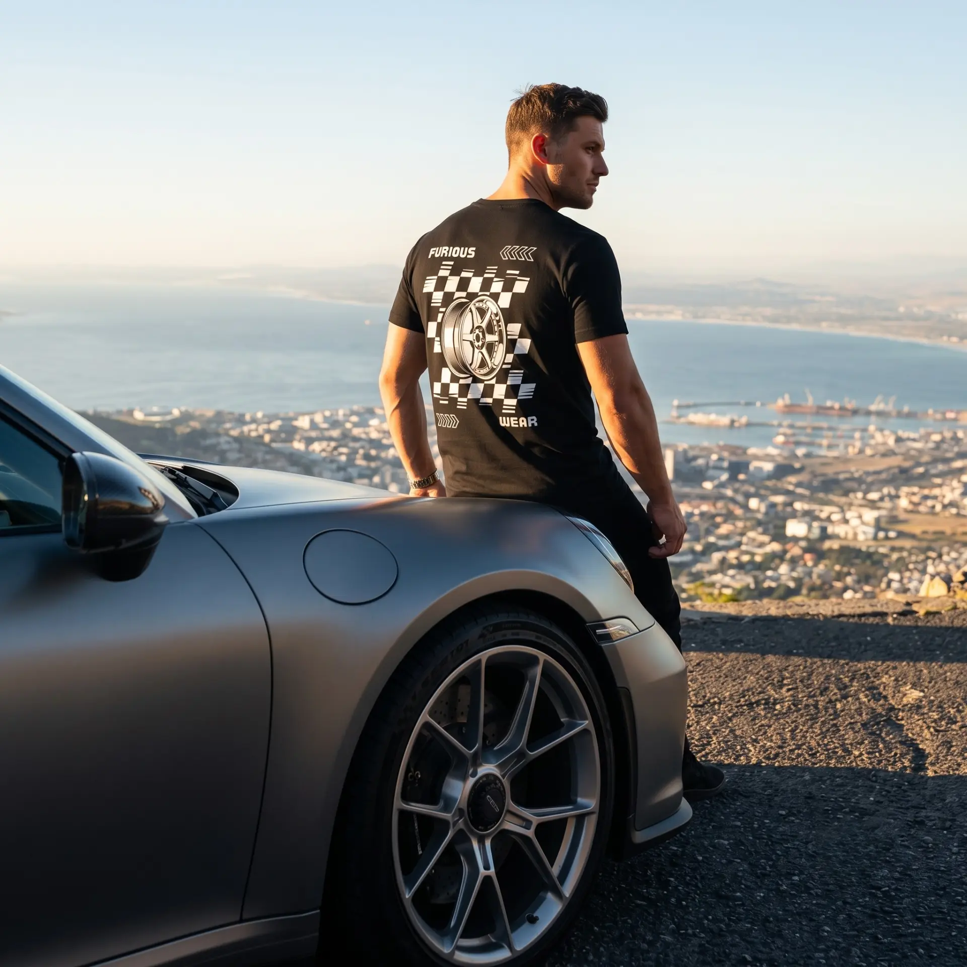 Model overlooking the bay wearing the black Furious Wear wheel back-print tee